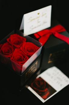 A beautifully arranged gift box with flowers and personalized notes inside.