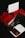 A close-up of a transparent box containing vibrant red roses sits prominently. In the background, there is a black gift box tied with a red ribbon. An elegant card with cursive writing is partially visible, adding a touch of personalization to the gift.
