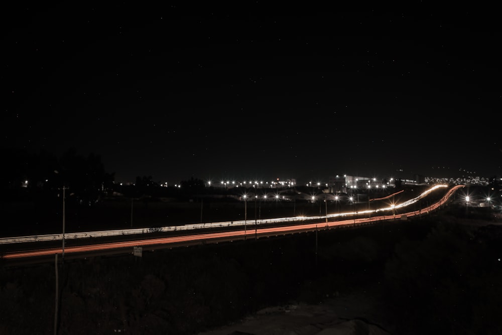 a long exposure photo of a highway at night