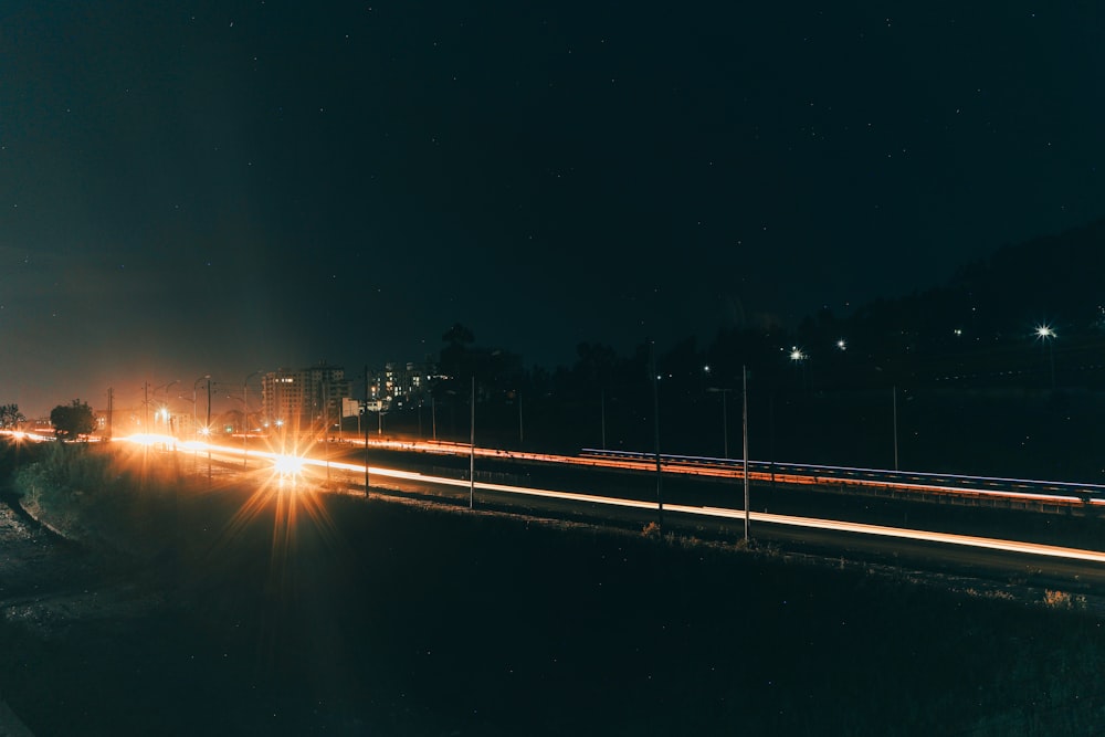 a city street at night with light streaks