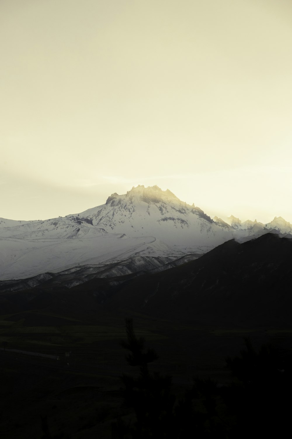 a snow covered mountain is seen in the distance