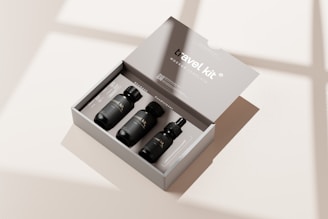 three bottles in a box on a table