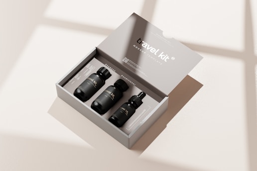three bottles in a box on a table