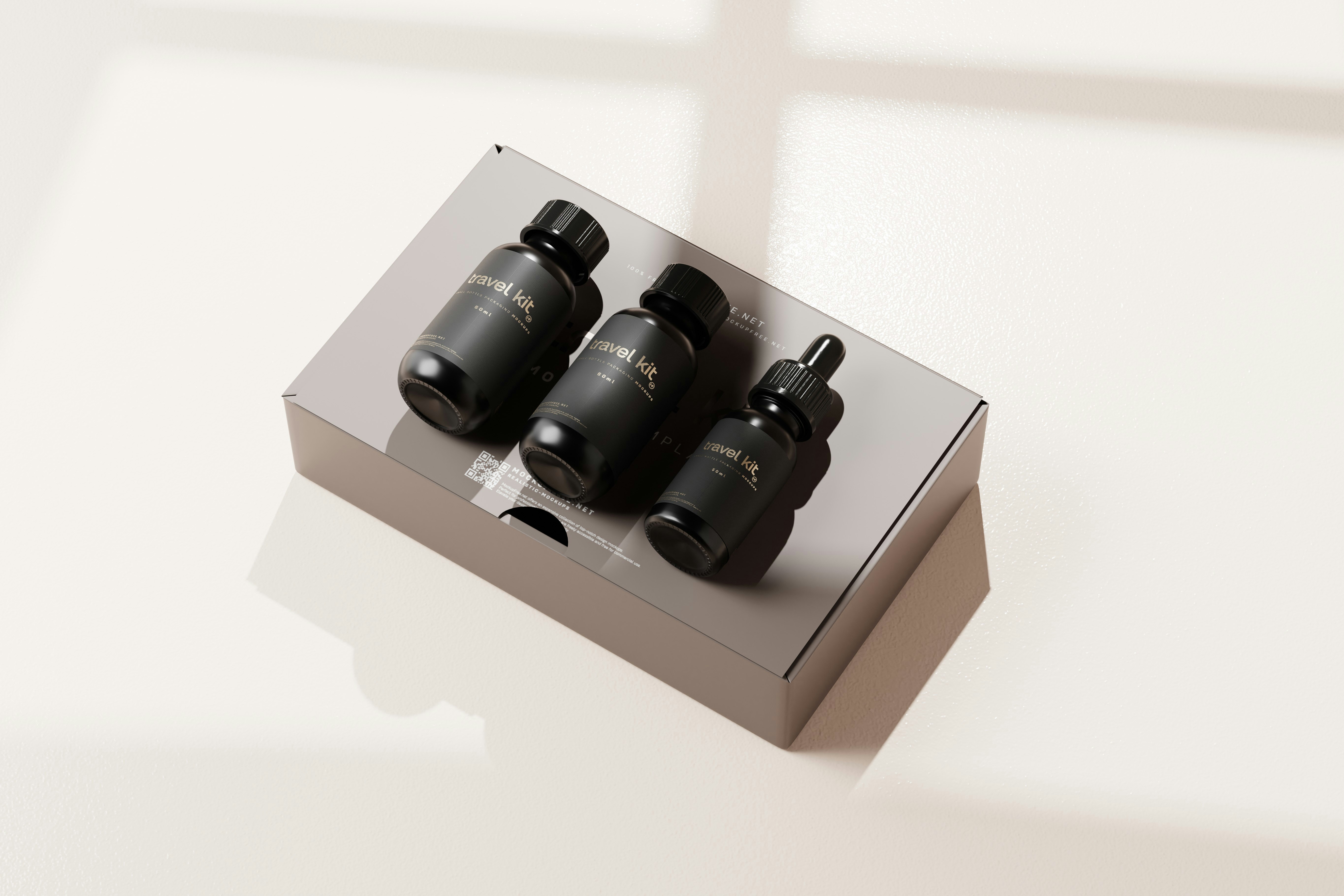 three black bottles sitting in a box on a table