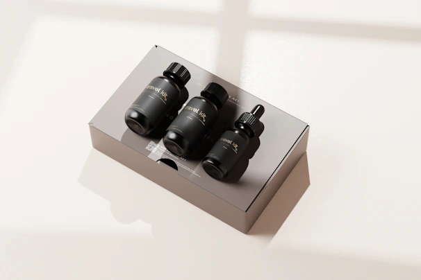 Travel bottles perfectly arranged in a clear toiletry pouch illuminated by natural bathroom light.