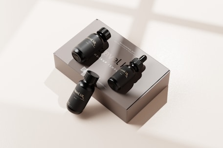 Set of liquid foundation bottles with different shades displayed on a mirrored surface