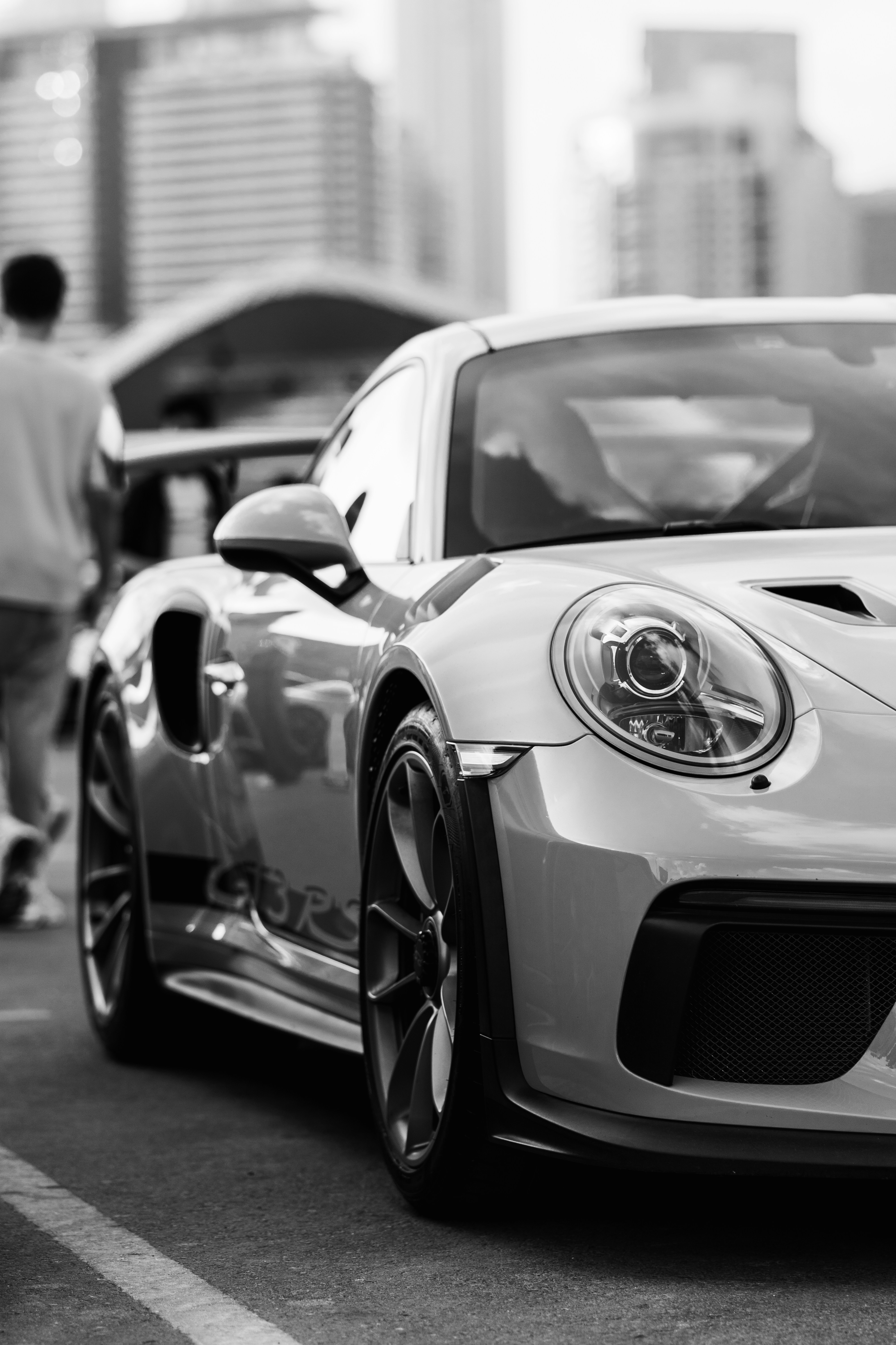 a white sports car parked in a parking lot