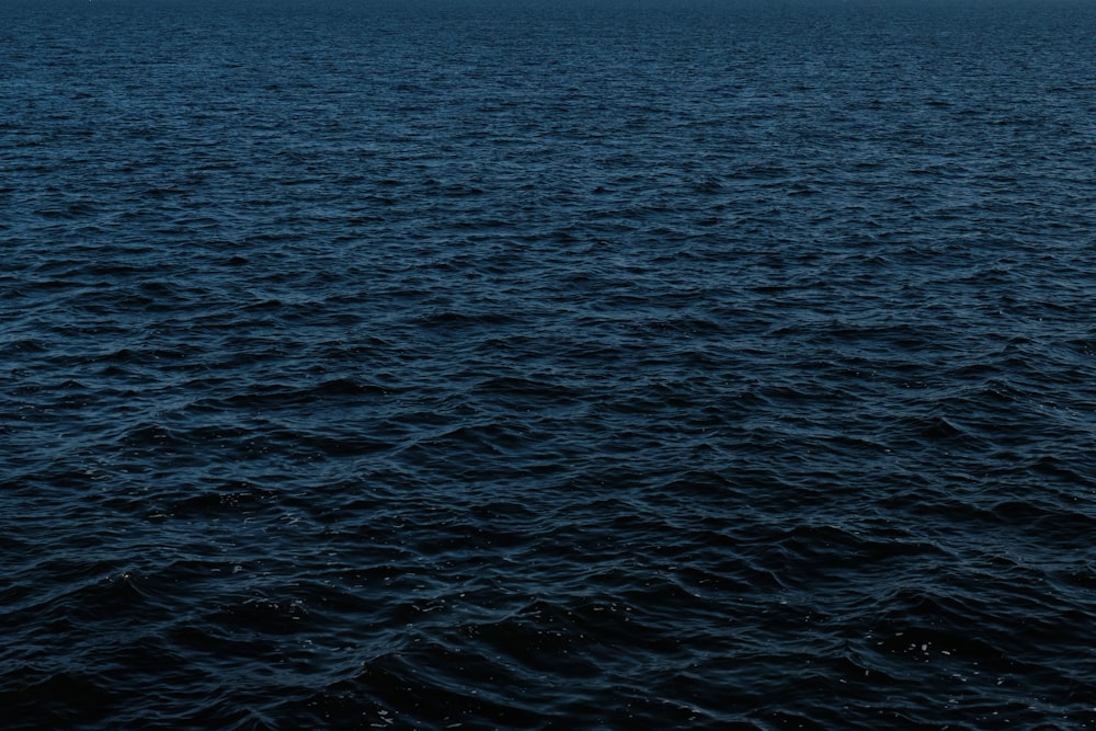 a large body of water sitting under a cloudy sky