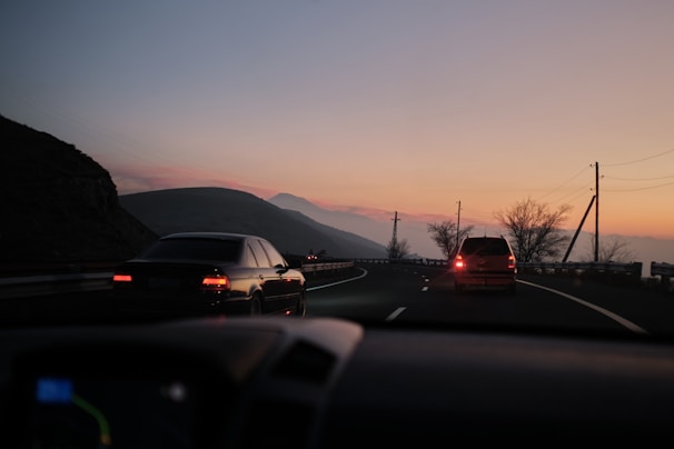 a couple of cars that are sitting in the street