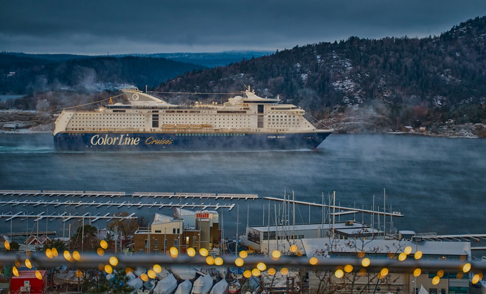 a cruise ship in the water near a dock