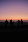 A sunset backdrop highlighting a group of activists in discussion.