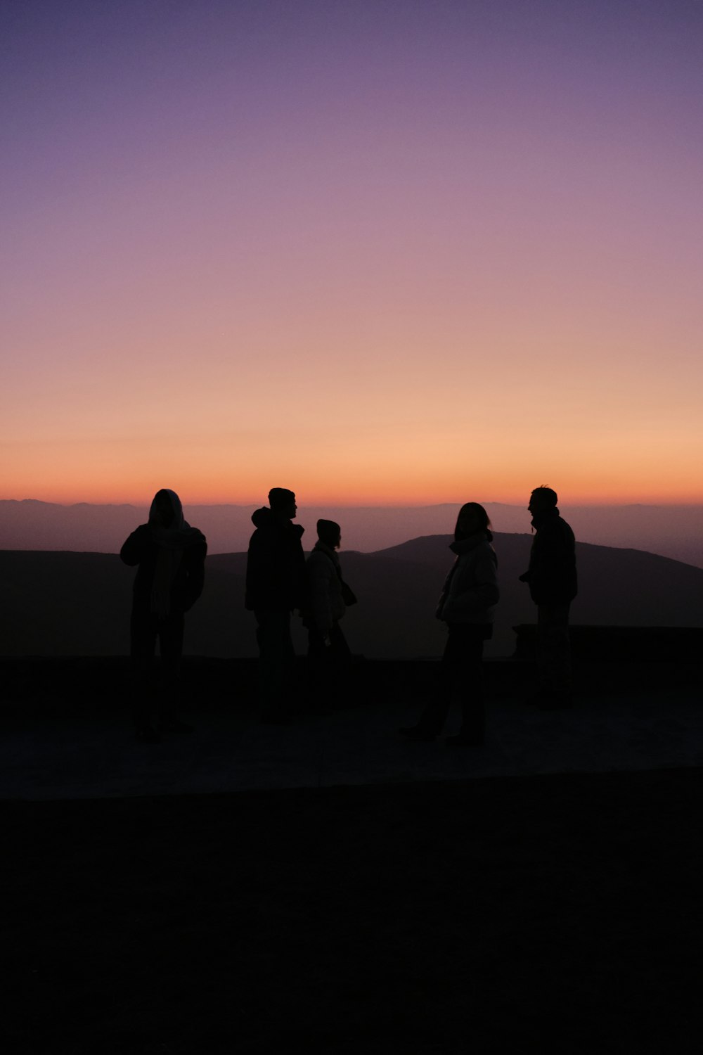 a group of people standing on top of a hill