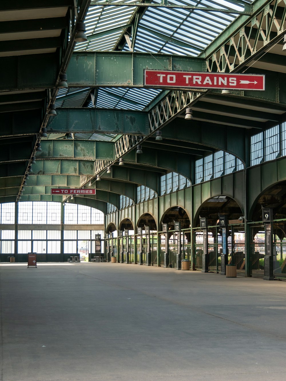 a train station with a sign that says to trains