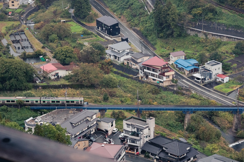 an aerial view of a city with a train on the tracks