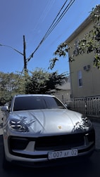 An attractive car parked outside a house, symbolizing ownership.