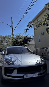 An attractive car parked outside a house, symbolizing ownership.