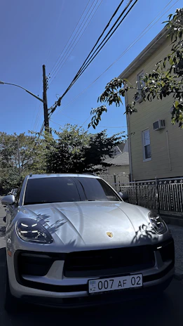 Sir Leak Detection van parked outside a suburban home on a sunny day.