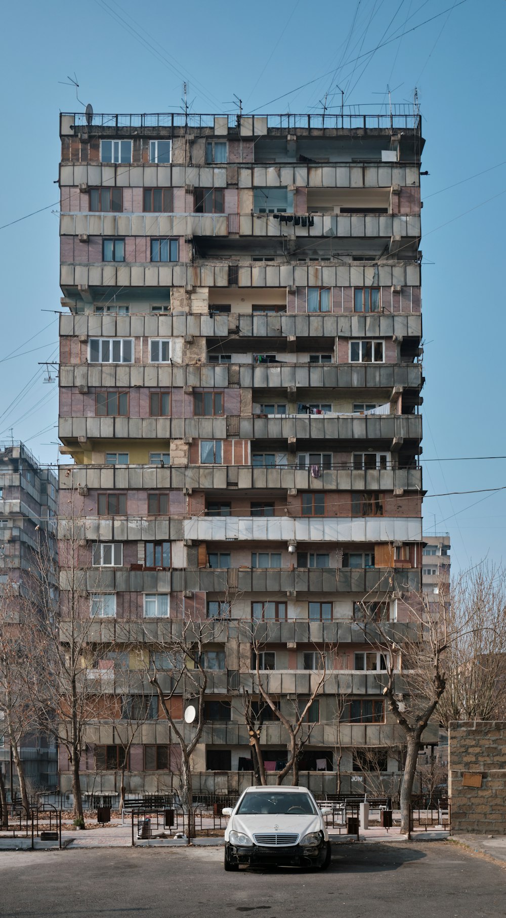 a car parked in front of a tall building