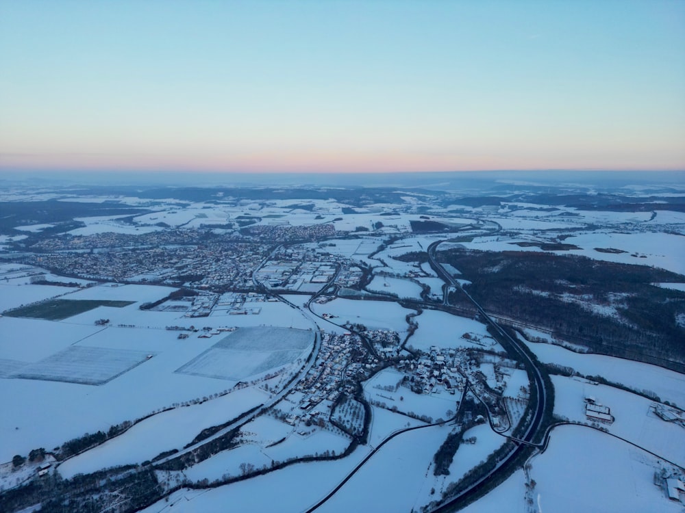 an aerial view of a snow covered landscape