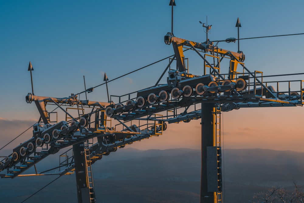 a very tall metal structure with lots of wires on top of it