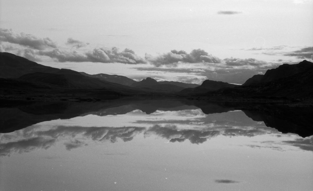 a black and white photo of a mountain lake