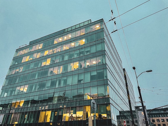A sleek energy consultancy office with navy blue accents and a view of industrial energy infrastructure.