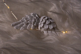 A serene workspace blending soft pink and gold tones with subtle sacred geometry and delicate angel wings.