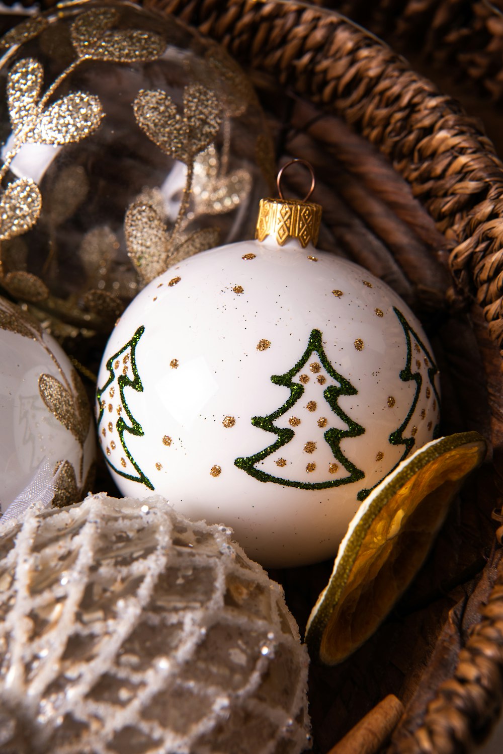 a basket filled with christmas ornaments on top of a table