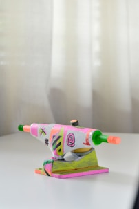 A set of professional skateboarding trucks laid out neatly on a wooden table.