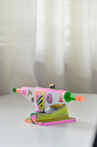 A display of shiny skateboard trucks and wheels arranged on a wooden table with Salt Lake City skyline in the background.