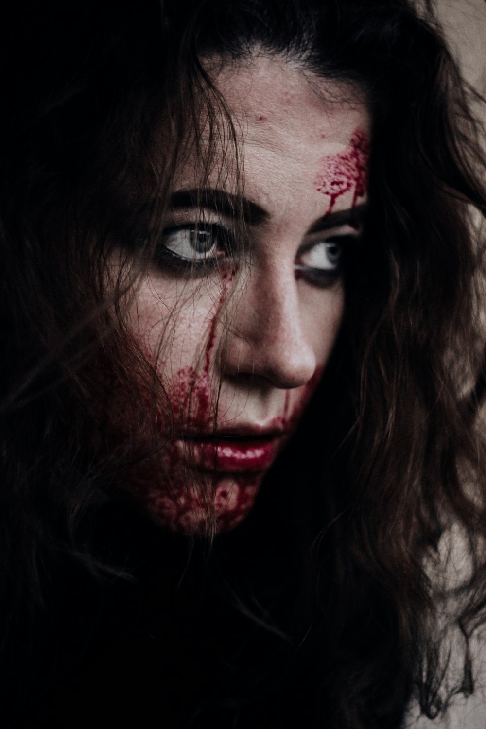 a woman with blood all over her face