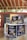 Several cans of flavored coffee, including charcoal and sea salt varieties, are arranged on a wooden table. The packaging features vibrant and colorful designs with cartoon characters. A box in the background displays more coffee cans, and some blurred text appears on a wall.