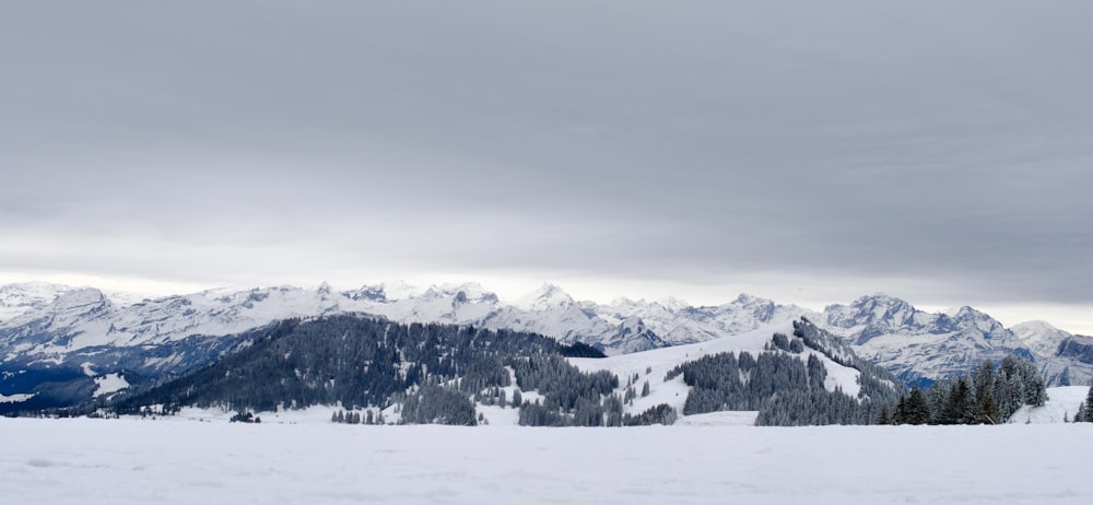 a person on skis in the snow with mountains in the background