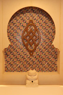 A niche design ring with intricate patterns displayed on a marble slab.