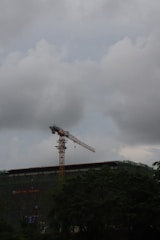 Engineer inspecting construction site against a cloudy sky.