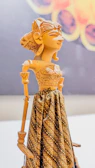 Close-up of an intricately carved wooden marionette hand with delicate paintwork.