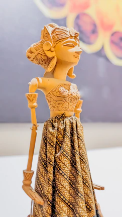 Close-up of an intricately carved wooden marionette hand with delicate paintwork.