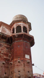 a tall tower with a clock on the top of it