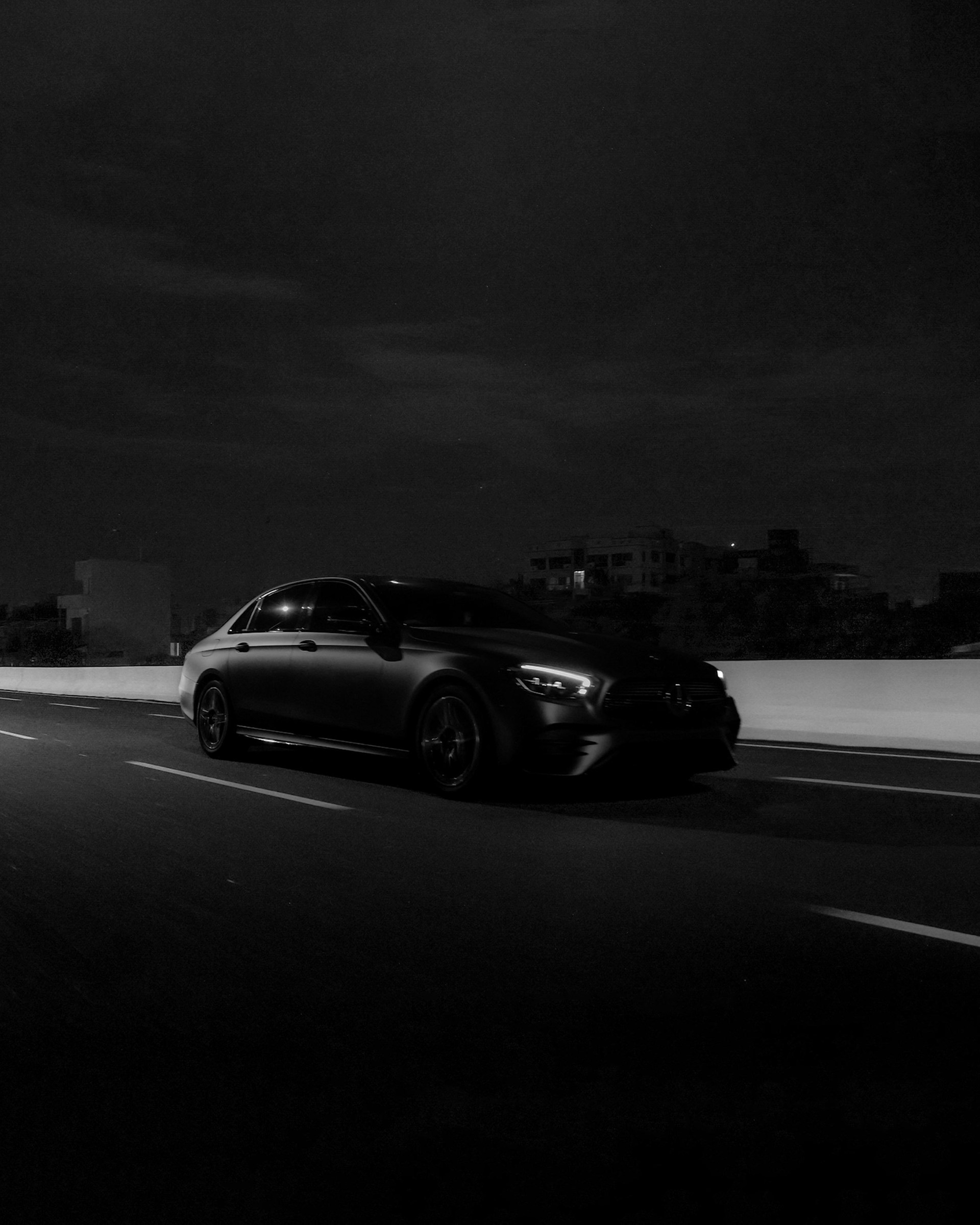 a car driving down a highway at night