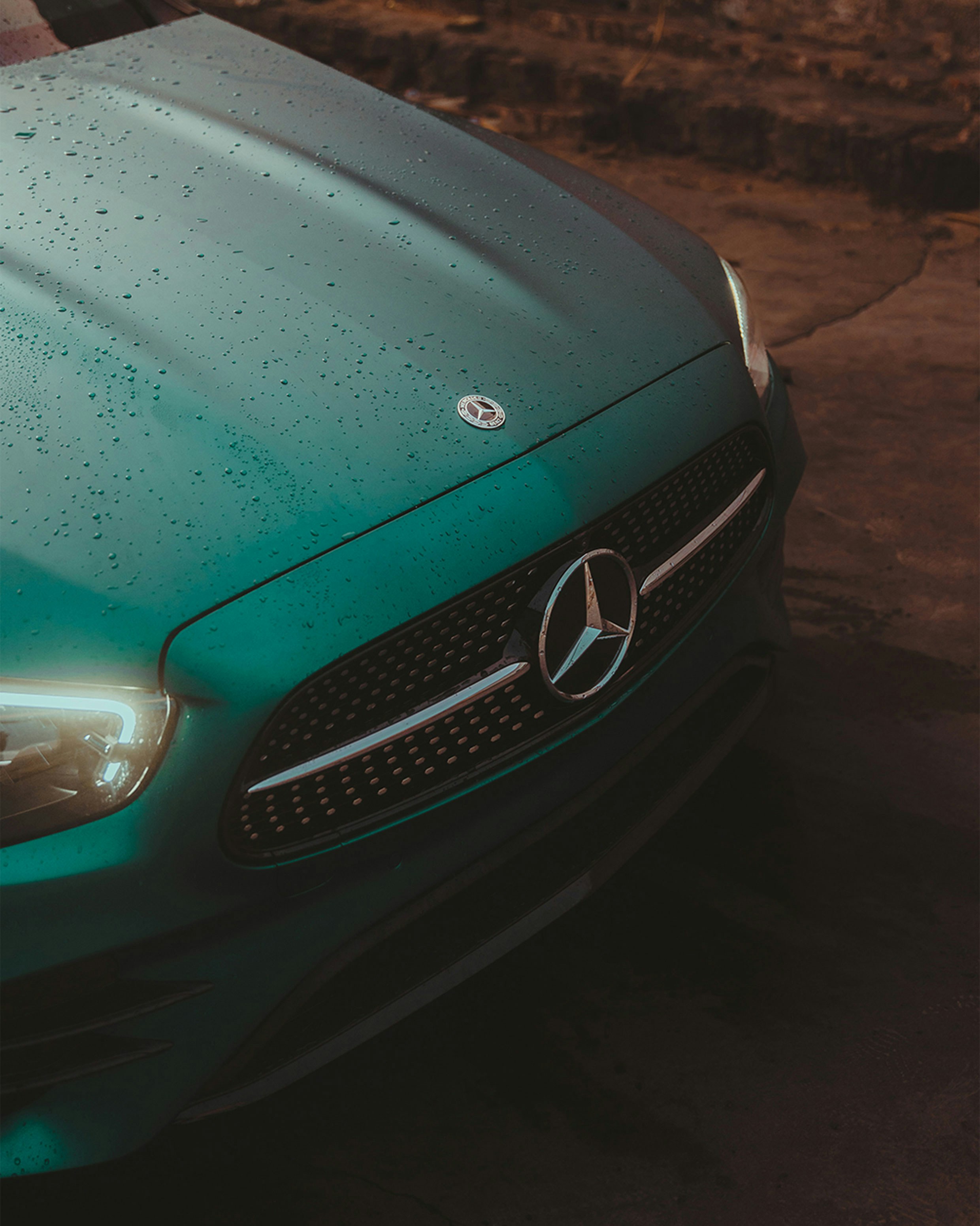 a close up of the front of a green mercedes cla