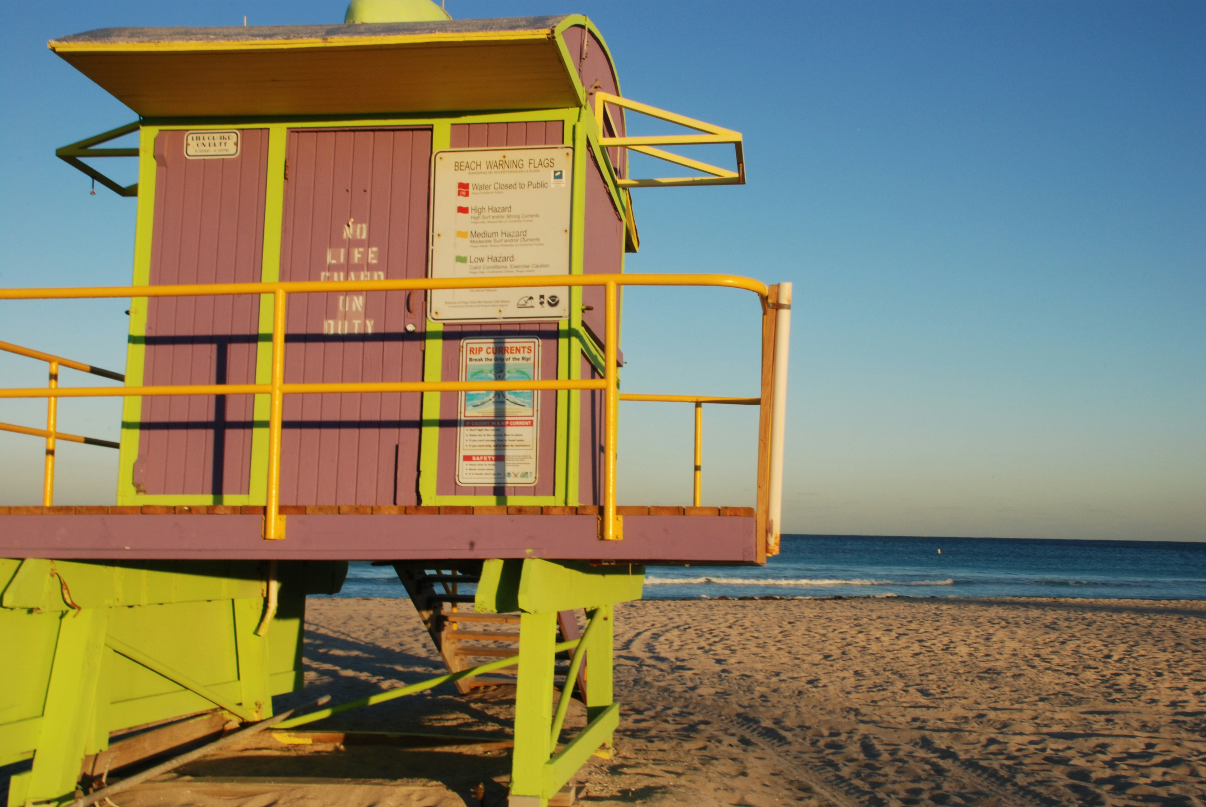 a life guard stand on a beach near the ocean