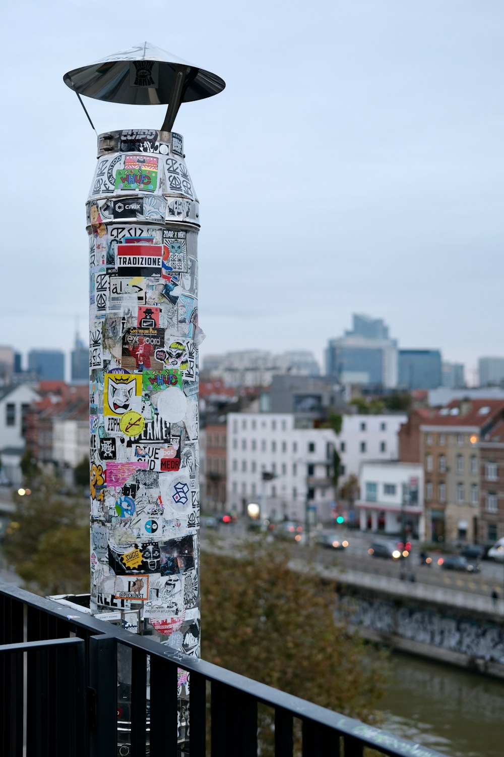 a tall pole with a lot of stickers on it