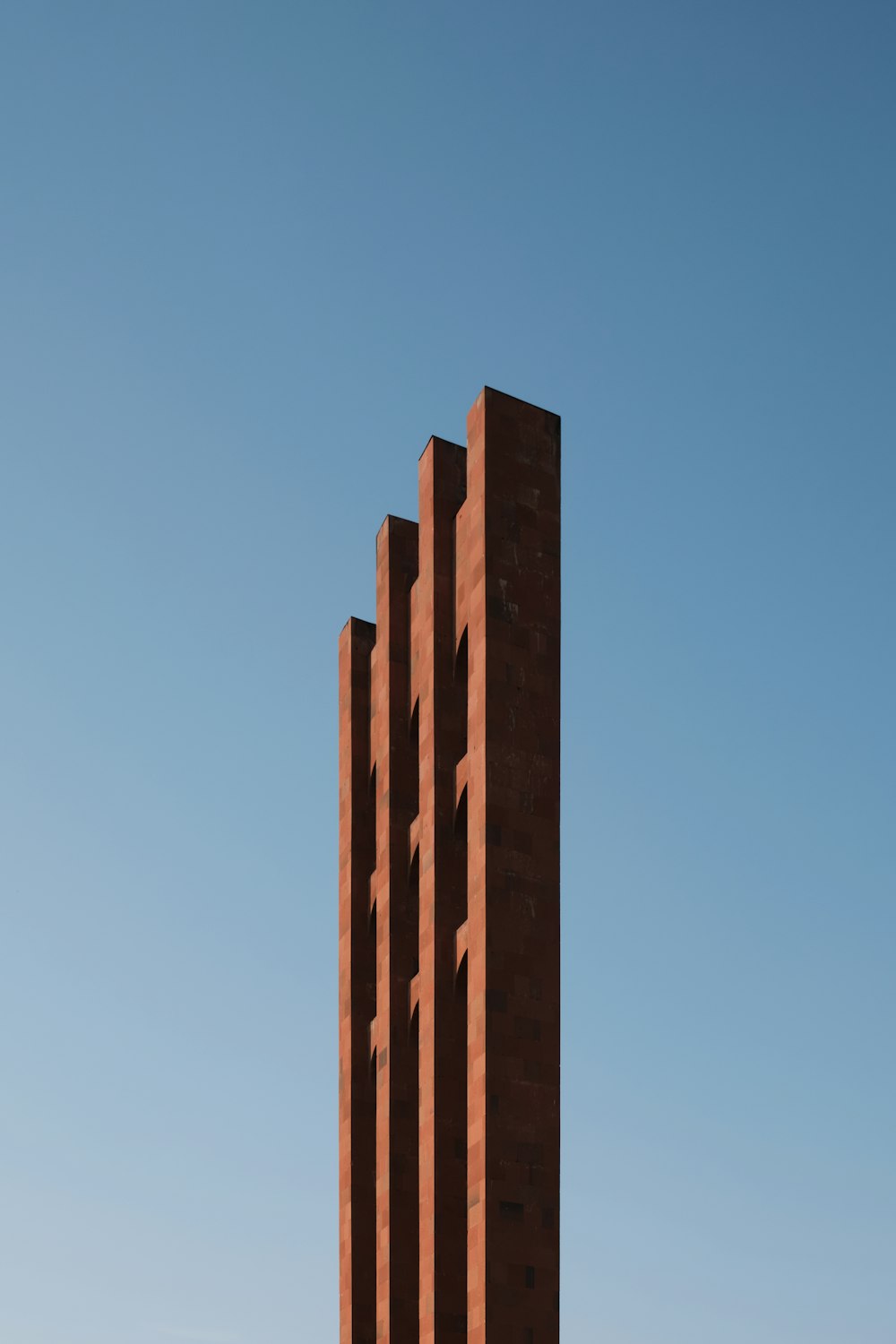 a tall brick building with a sky background