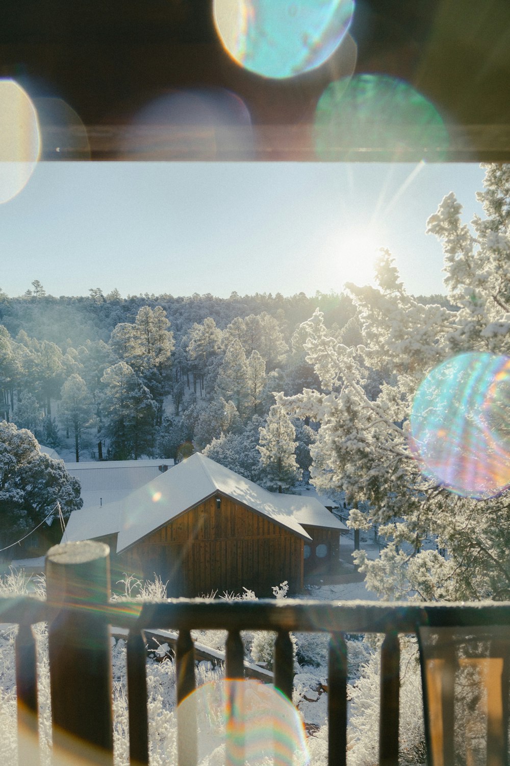 a view of a cabin in the woods from a balcony