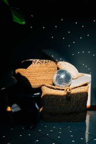 A styled corner featuring a seagrass basket, rattan decor, and a canvas print blending textures beautifully.