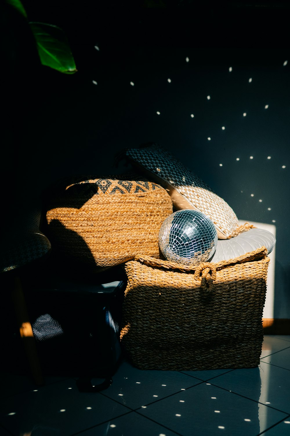 a wicker chair with a disco ball on top of it