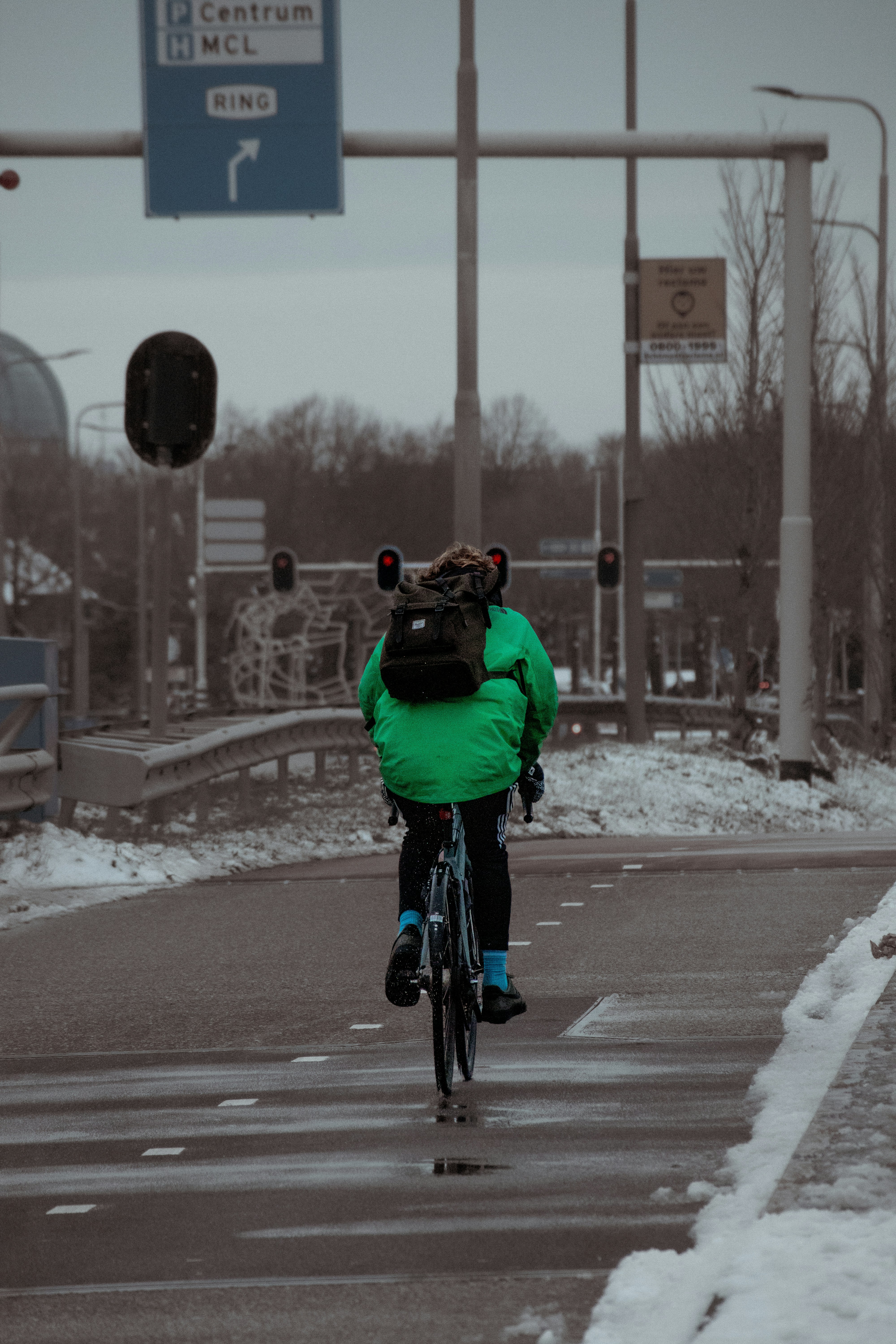 a person riding a bike down a street
