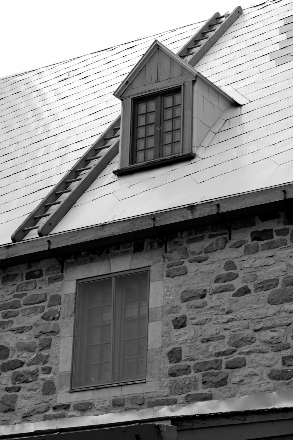 a black and white photo of a brick building with a window