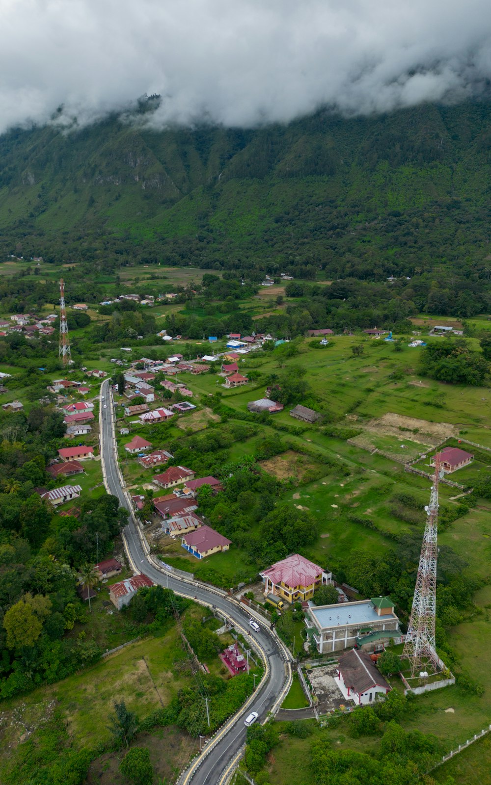 an aerial view of a town with a mountain in the background