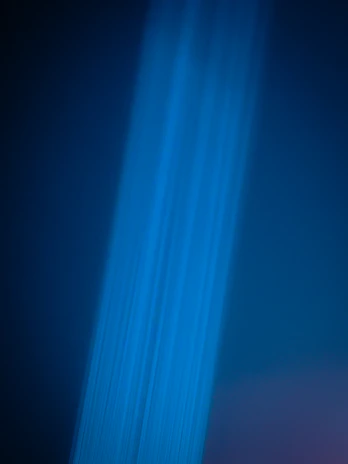 A dynamic shot of a quantalux product in action, emitting a soft blue light in a dark room.